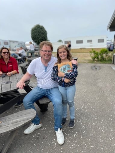 foto av en mann og en jente som holder en aktivitetsbok.